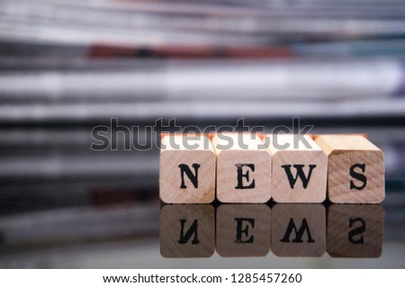 Wooden letters on background “news”