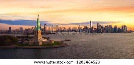 Liberty statue in New York city with manhatttan background and sunset, New York, USA Royalty-Free Stock Photo #1285464523