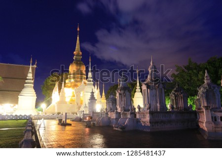 golden pagoda and white pagoda in temple with twilight sky background 