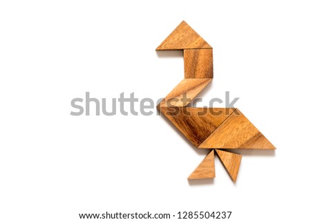 Wood tangram puzzle in walking swan or duck shape on white background