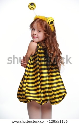 Cheerful funny little girl as a bee on white background