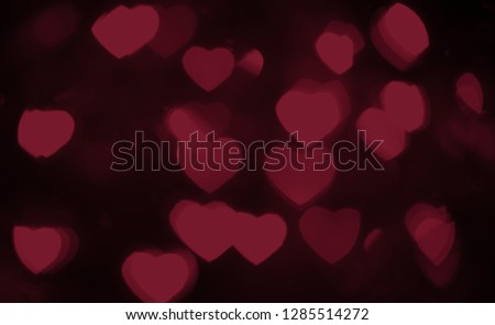 Background bokeh in the form of hearts of red and pink color. Copy space for text. The concept of romance and love. Valentine's Day. Shiny texture background. Festive background. 