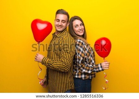 Couple in valentine day with balloons with heart shape