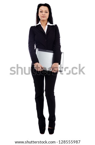 Confident businesswoman holding a laptop in her hands in full length pose isolated on white background. Business concept