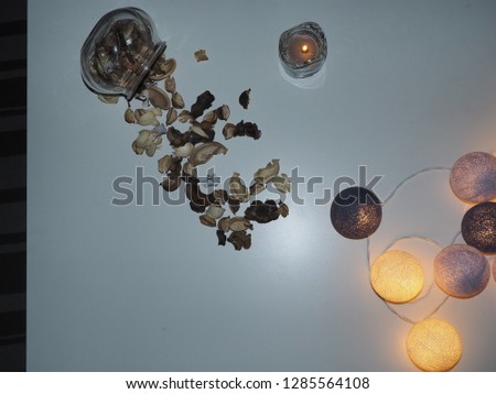 Flower vase,Glass dozen, dried flowers, yellow light on a white table