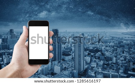 Hand holding mobile smart phone, empty white screen, Osaka city, Japan background