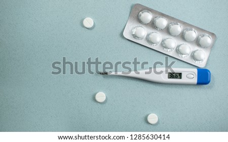 Medical background with multi-colored packs of pills. concept pharmacy, clinic, drugs, headache medicine. Image on illness, flu, treatment. Image of a thermometer with a normal temperature