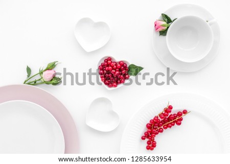 Empty white and pink colorful plate and wineberry for table setting on white table backgroung top view