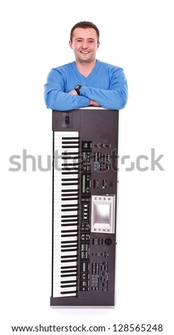 Smiling young man staying behind an electronic instrument over white background