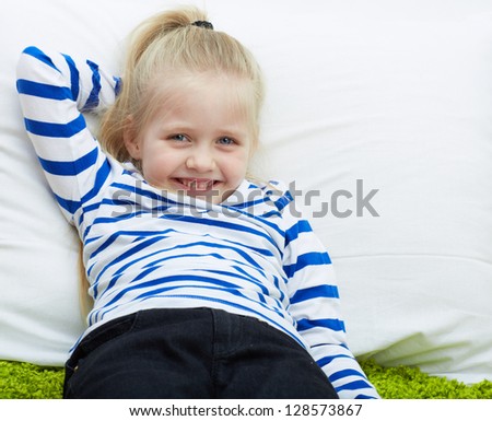 Little girl portrait . Kid lying and relax.