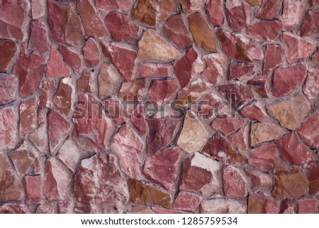 Part of a red stone wall, for background or texture.