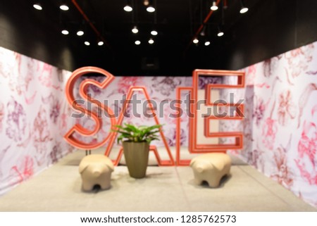 Abstract blurred photo of fashion department stores.Sale Logo.