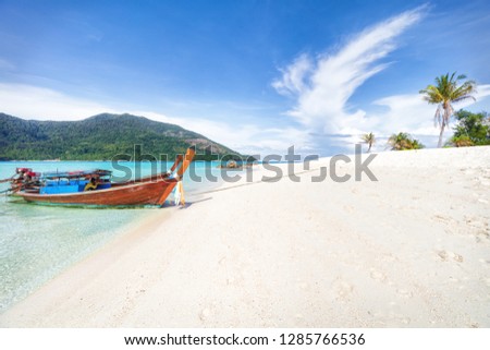 Empty sunny Koh Lipe Bulow Beach panorama with long tail wooden boats Royalty-Free Stock Photo #1285766536