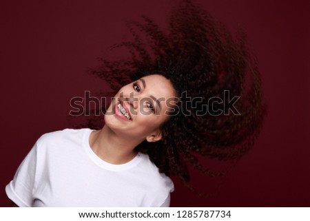 Studio photo of inspired african lady dancing with eyes closed. Indoor portrait of relaxed black girl isolated on purple