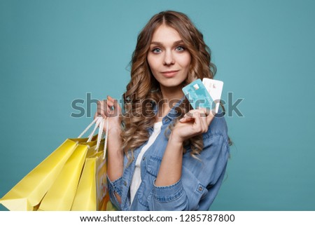 Young beautiful woman holding shopping bags and a credit