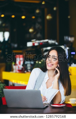Business woman using laptop at cafe and working on computer.