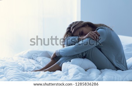 Depressed woman awake in the night, she is exhausted and suffering from insomnia Royalty-Free Stock Photo #1285836286