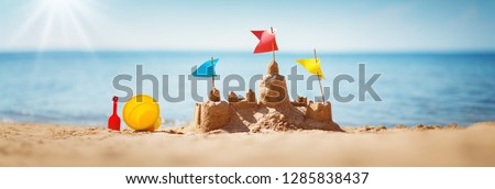 Sandcastle on the sea in summertime Royalty-Free Stock Photo #1285838437