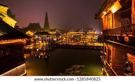 Night view of generic ancient town with water reflection. Traditional building along historic water town Wuzhen China