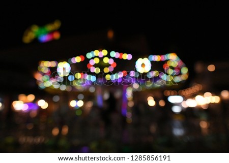 Defocused scene of walking street with festive lights, colorful shopping place at night.