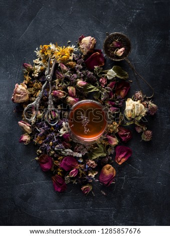 Floral background. Herbal tea, dried herbs and flowers and vintage scissors, top view