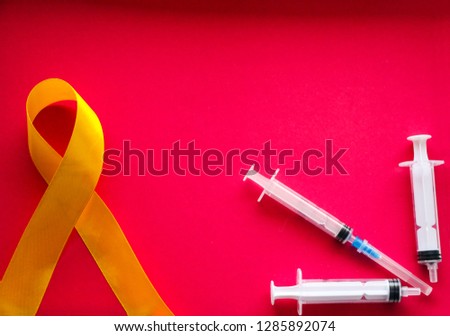 golden ribbon and medicine. concept -  symbol of childhood cancer, pediatric oncology