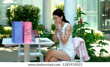 The young pretty woman was excited and closed her mouth with two hand and looking to laptop with delighted