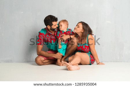 Adorable little baby with his parents on vintage grunge background