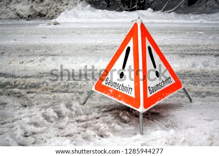 German sign on street with snow, warning of Forrest work