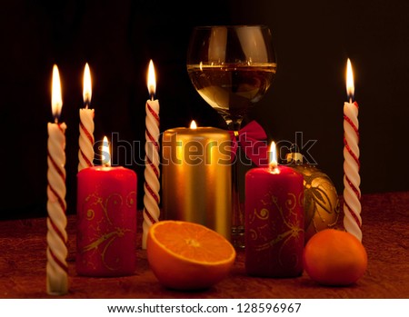 Christmas decoration glass with champagne and burning candles