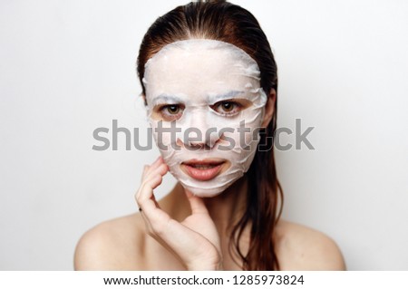  young woman in a cosmetic mask with wet hair portrait                             