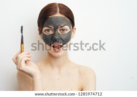 woman in clay spa mask