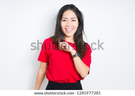 Beautiful brunette woman wearing red t-shirt over isolated background Dancing happy and cheerful, smiling moving casual and confident listening to music