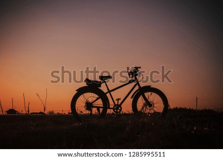 Bike silhouette on the sunset background.