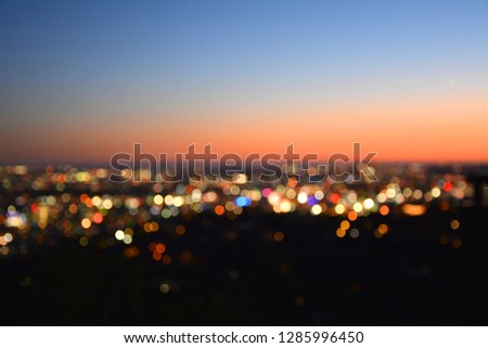 Bokeh lights of a city at sunset.