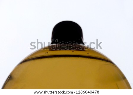  Brown beer bottle, image of aqueous liquid on a white background close up           