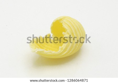 Roll of butter on an isolated background. Picture is ideal for advertising all kinds of dairy products