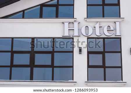 signboard hotel on the wall of the house
