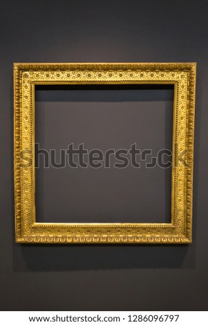 Blank vintage empty picture frame on grey wall