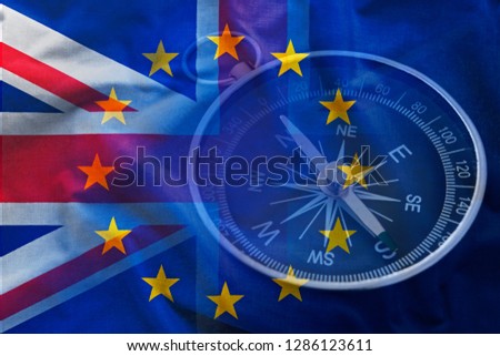 Closeup image of retro compass against overlapped flags of Great Britain of European Union