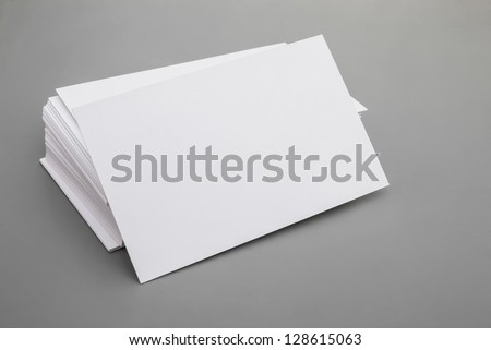 blank business cards stack up on grey background, good for text & logo