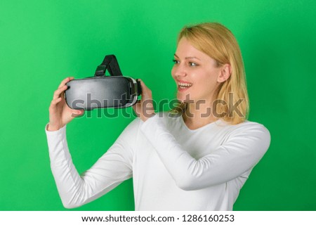 Amazed young woman touching the air during the VR experience. Young woman using a virtual reality headset. The woman with glasses of virtual reality. Visual world