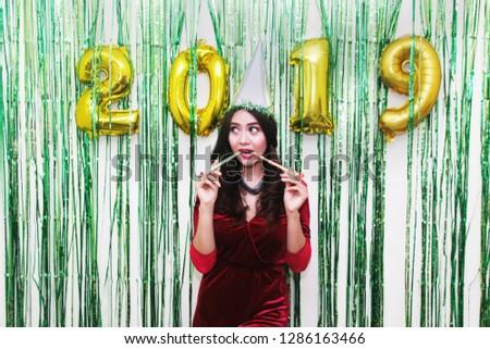 happy party asian with hat and whistle on 2019 balloons. new year celebration woman.