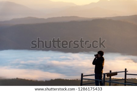 Photographer Landscape Nature Outdoor Hat. during mist sunrise , relax and freedom day. Lifestyle Concept.