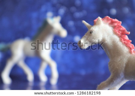 Two magical unicorn on a blue star background