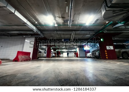 Underground public garage parking with cars, movie style toned