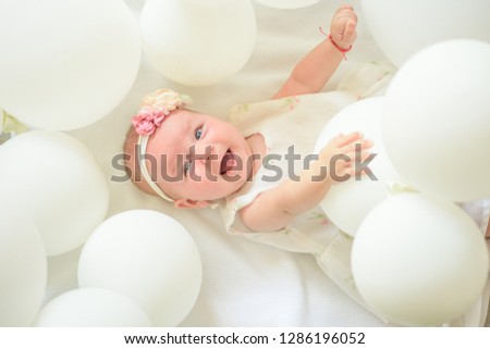 Only fresh and healthy food for my baby. Sweet little baby. New life and birth. Small girl. Happy birthday. Family. Child care. Childrens day. Portrait of happy little child in white balloons.