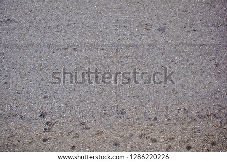 Asphalt road showed rough surface and grain of material components of them with some dirty on the surface from car and people.