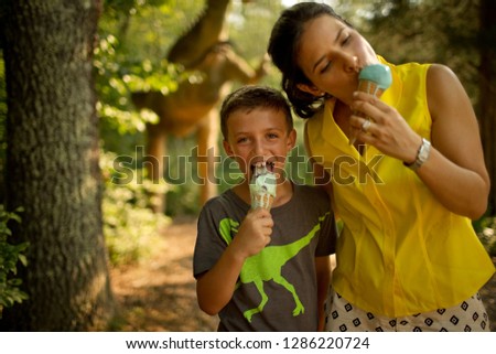 Portrait of a smiling mother and son eating ice cream.