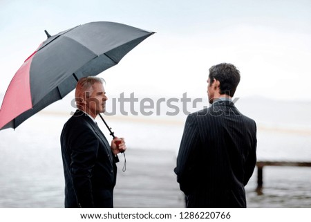 Two business partners talking on the pier.